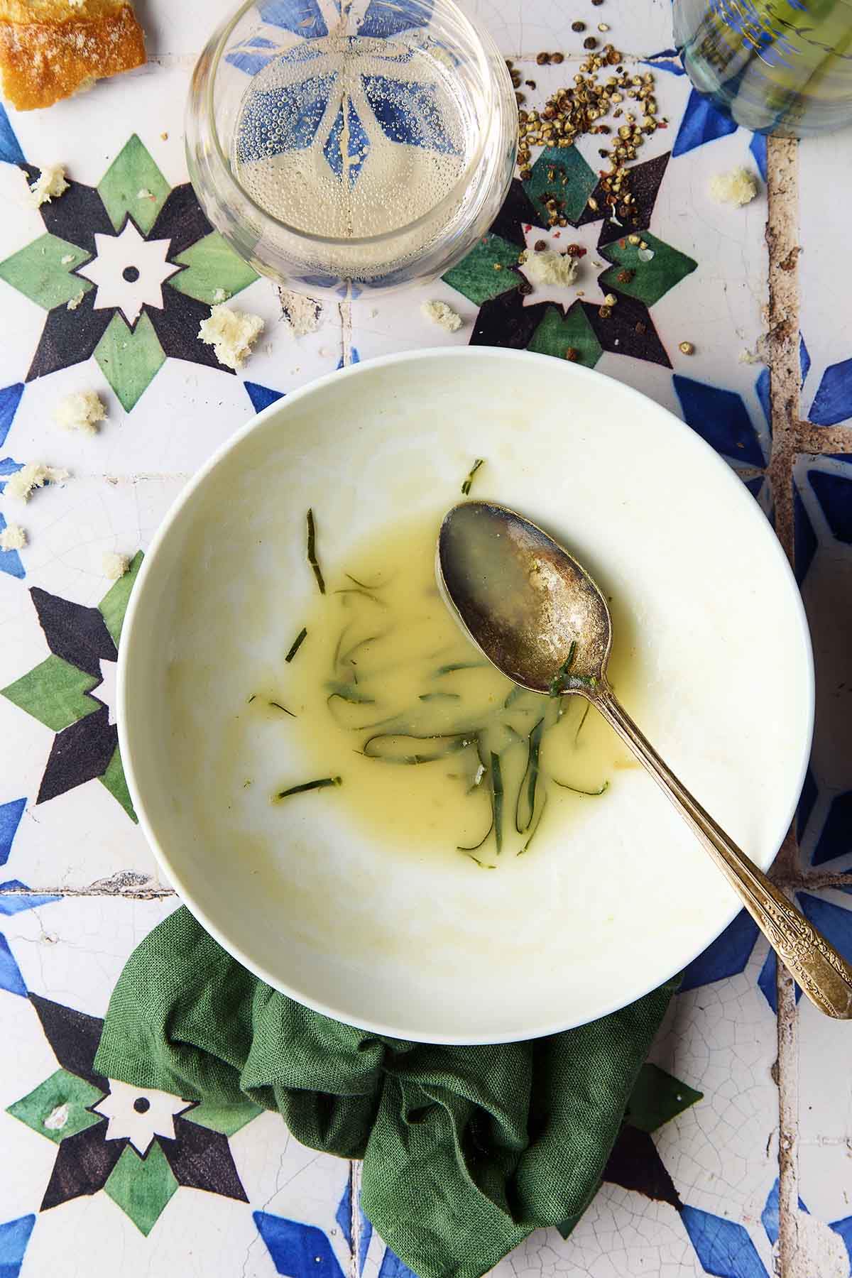 A empty bowl of caldo verde, or Portuguese kale soup (green broth).