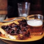 Pissaladière square on a plate with beer.