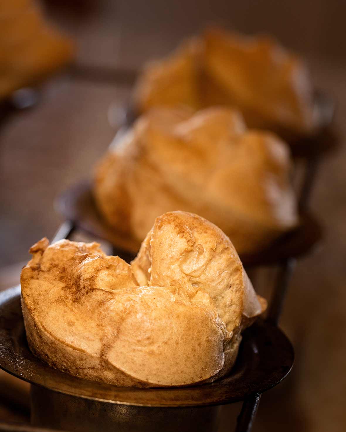 A popover with strawberry butter in a popover tin.