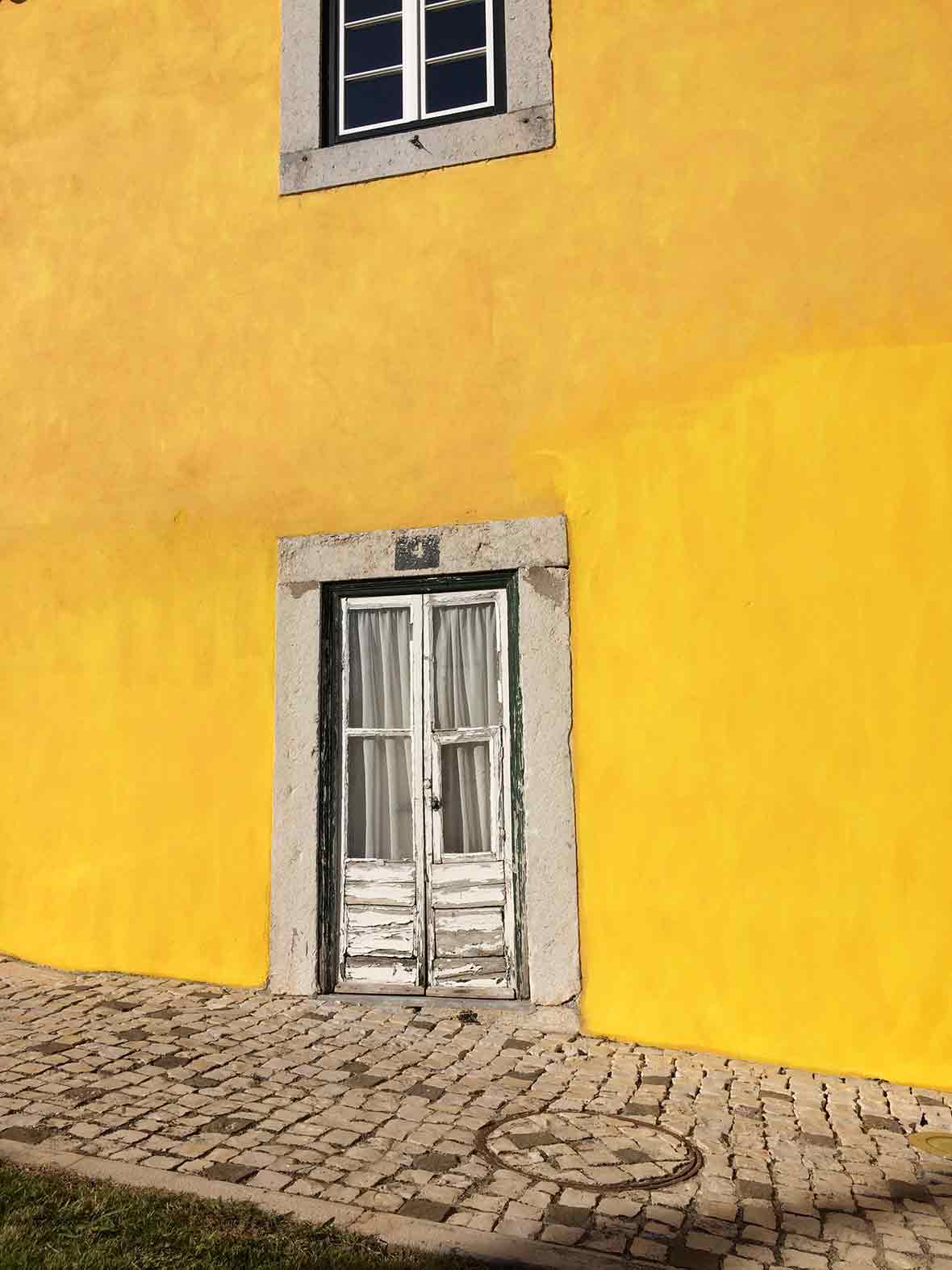 Door in a yellow wall in Lisbon