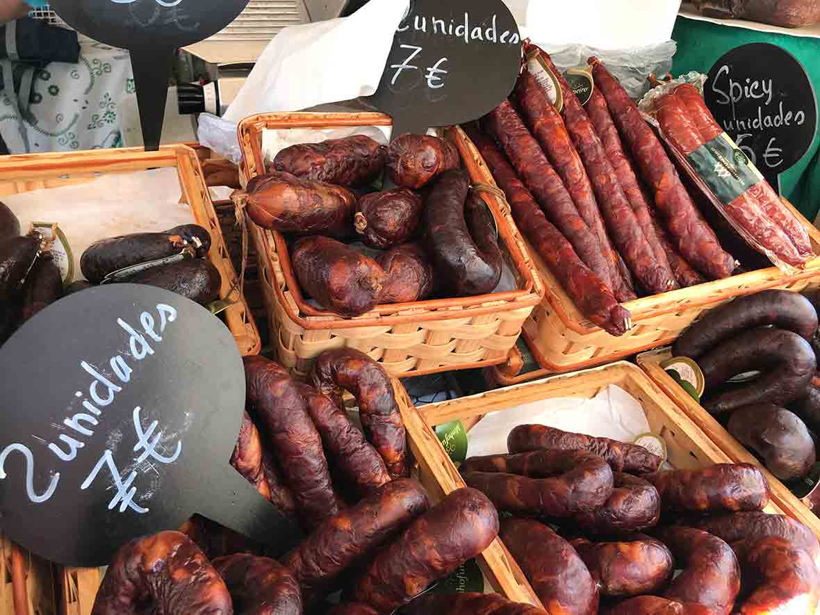 A stall in a food market in Lisbon with Portuguese sausages