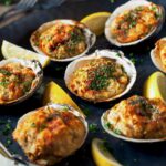 6 baked clams on a black platter