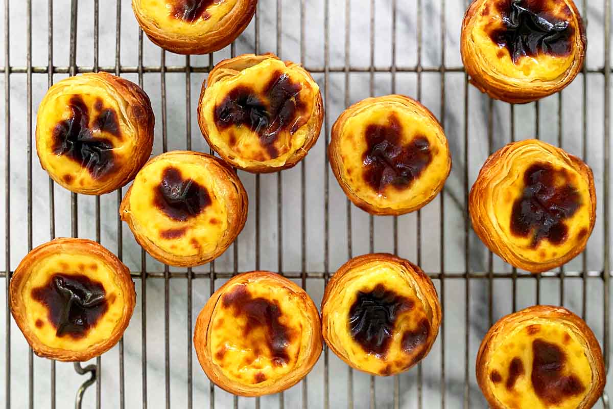 11 pastel de nata--Portuguese tarts--on a cooling rack.