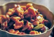 Bowl of stir-fried chunks of Chinese chicken, Sichuan peppercorns, celery, ginger, garlic