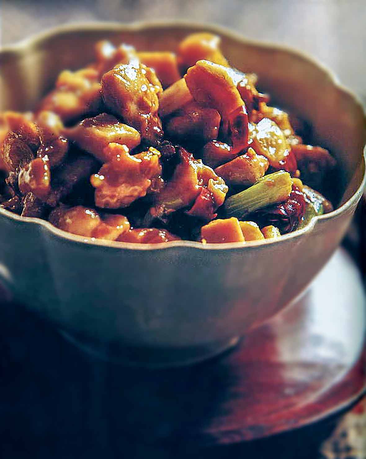 Bowl of stir-fried chunks of Chinese chicken, Sichuan peppercorns, celery, ginger, garlic