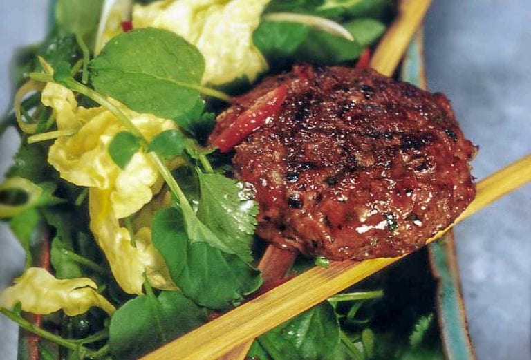 A spiced lamb burgers on a Vietnamese salad of watercress, scallions, mint, basil, cilantro