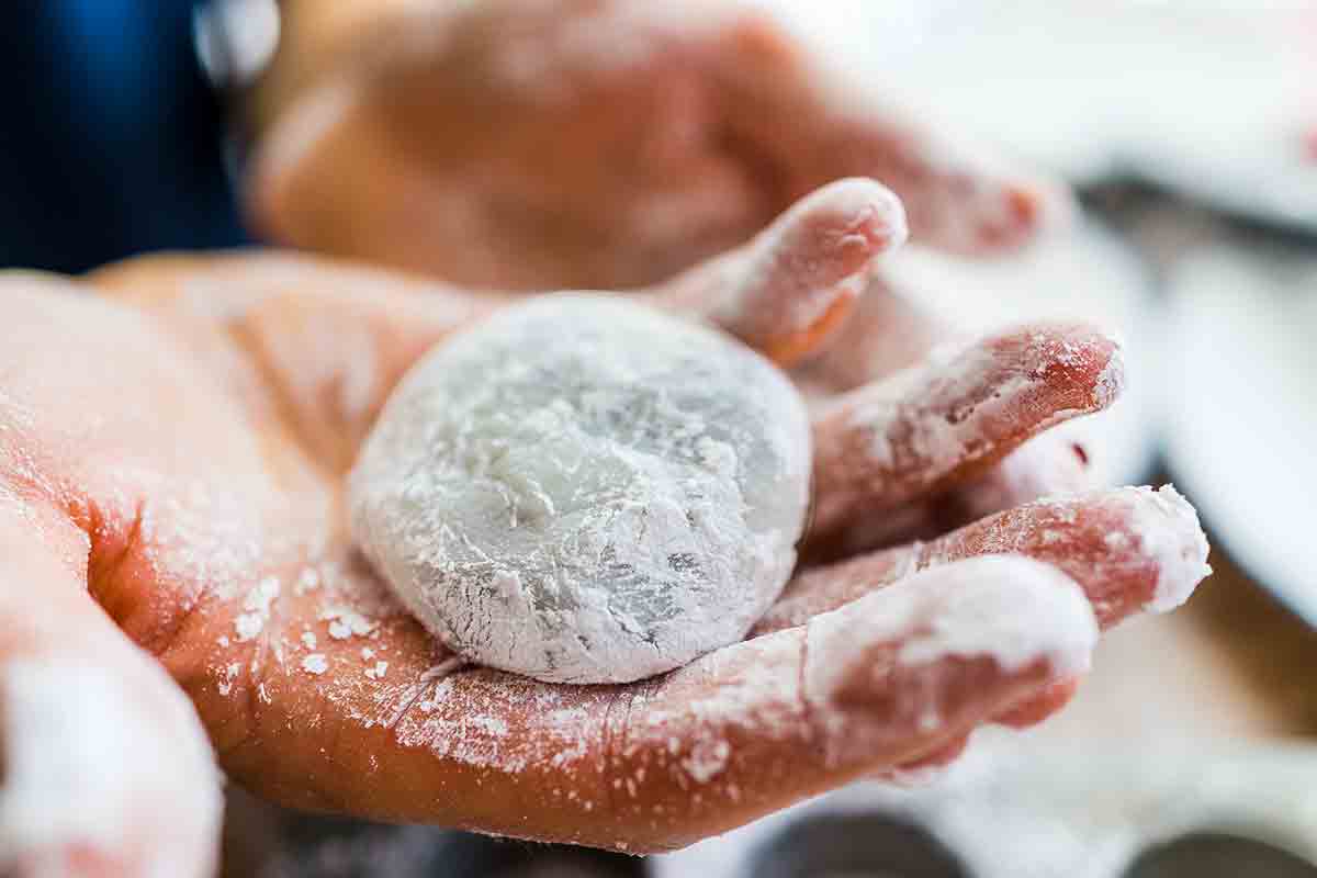 Man's hand holding a ball mad from glutineous rice flour.