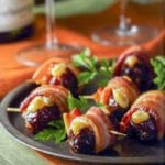 Plate of crispy bacon-wrapped stuffed dates held by toothpicks, parsley garnish