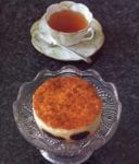 Far Breton French Custard Cake on cake stand with a cup of tea.