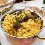 A copper pot of bacalhau a Bras--or Portuguese scrambled eggs, salt cod, potatoes, onions, olives, and parsley.