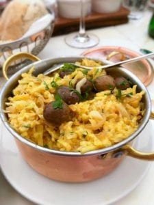 A copper pot of bacalhau a Bras--or Portuguese scrambled eggs, salt cod, potatoes, onions, olives, and parsley.