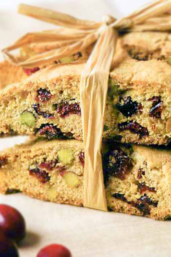 Several cranberry pistachio biscotti cookies tied together with raffia