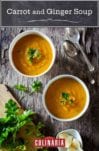 Two white bowls of carrot and ginger soup on a piece of wood