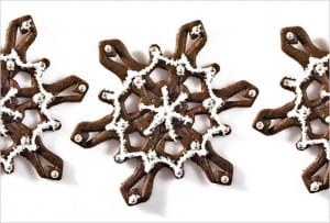 Three spicy snowflake cookies on a white background.