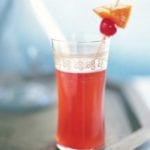 Red Singapore Sling with gin, cherry brandy, Benedictine, and triple sec in a tall glass with a cheery and pineapple skewer.