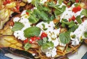 Baked eggplant topped with chiles, feta cheese and mint