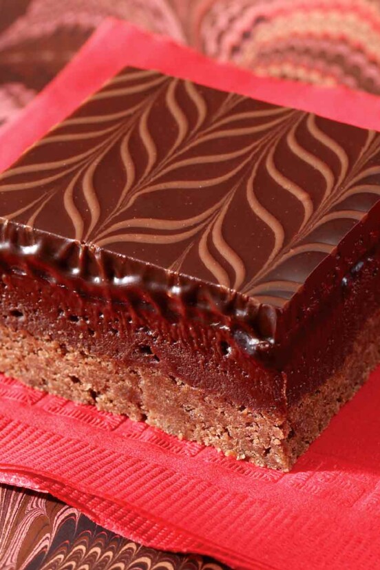 A raspberry-truffle brownie bar--layers of cocoa shortbread, raspberry brownie, and chocolate ganache swirled on top