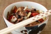 Spicy Chungking Pork in a bowl with chopsticks