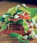A turkey cobb burger--a turkey hamburger on a bun with lettuce, tomato, bacon, blue cheese, and avocado