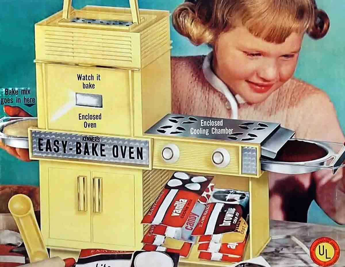 An ad for the vintage yellow Easy-Bake Oven with a girl pulling out a chocolate cake.