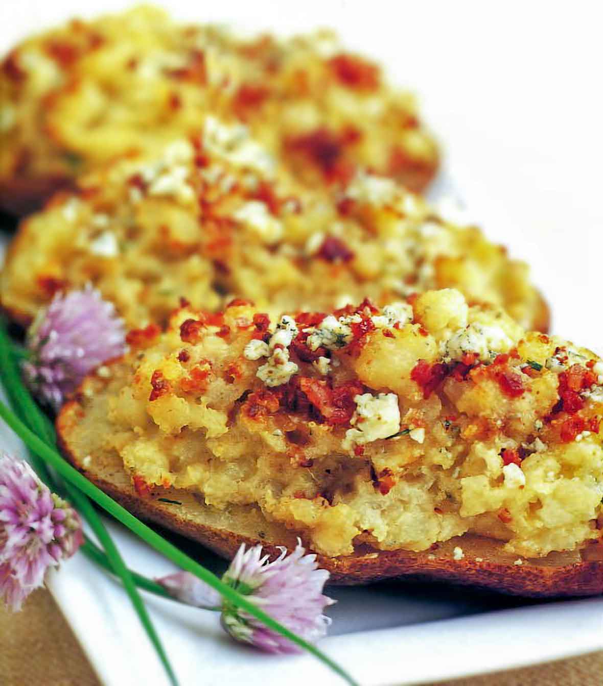 Three twice-baked potatoes with pancetta stuffing on a platter