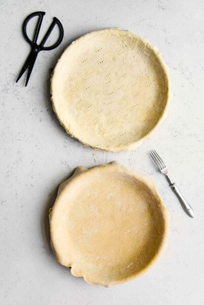 Two vinegar pie crusts in pie pans.