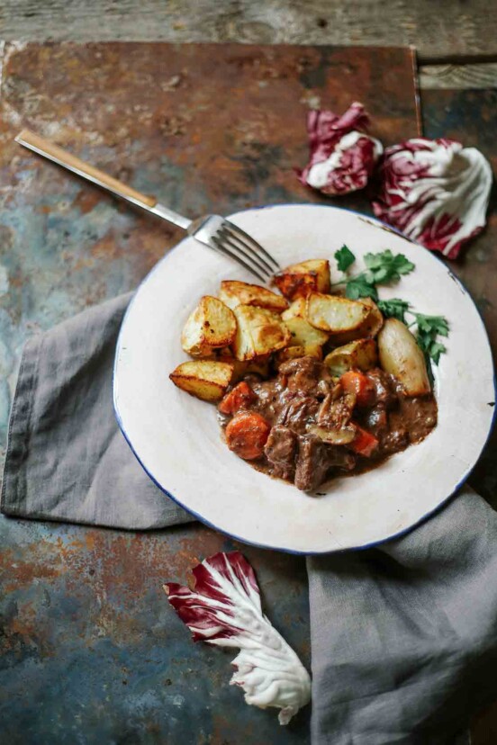 A plate of boeuf Bourguignon with roasted potatoes