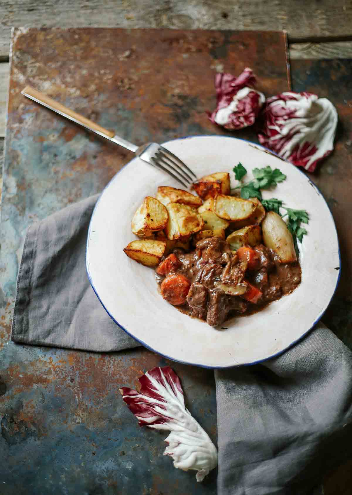 A plate of boeuf Bourguignon with roasted potatoes