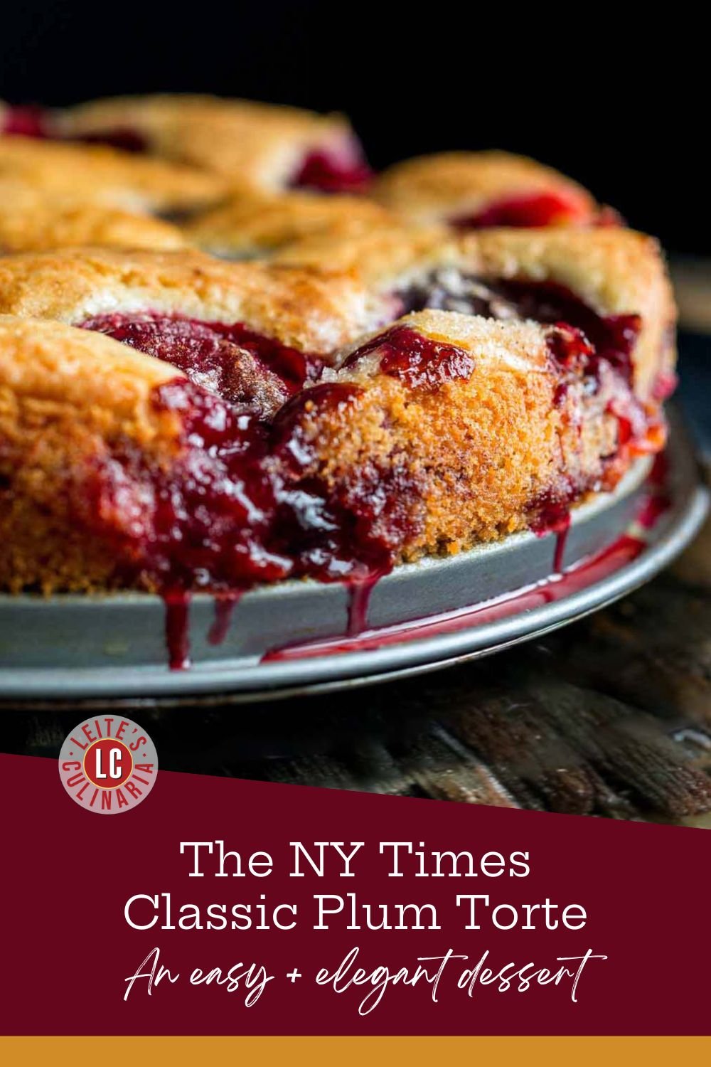 A plum torte with its jammy, dark purple juice bubbling over the top and dripping down the sides of the pan.