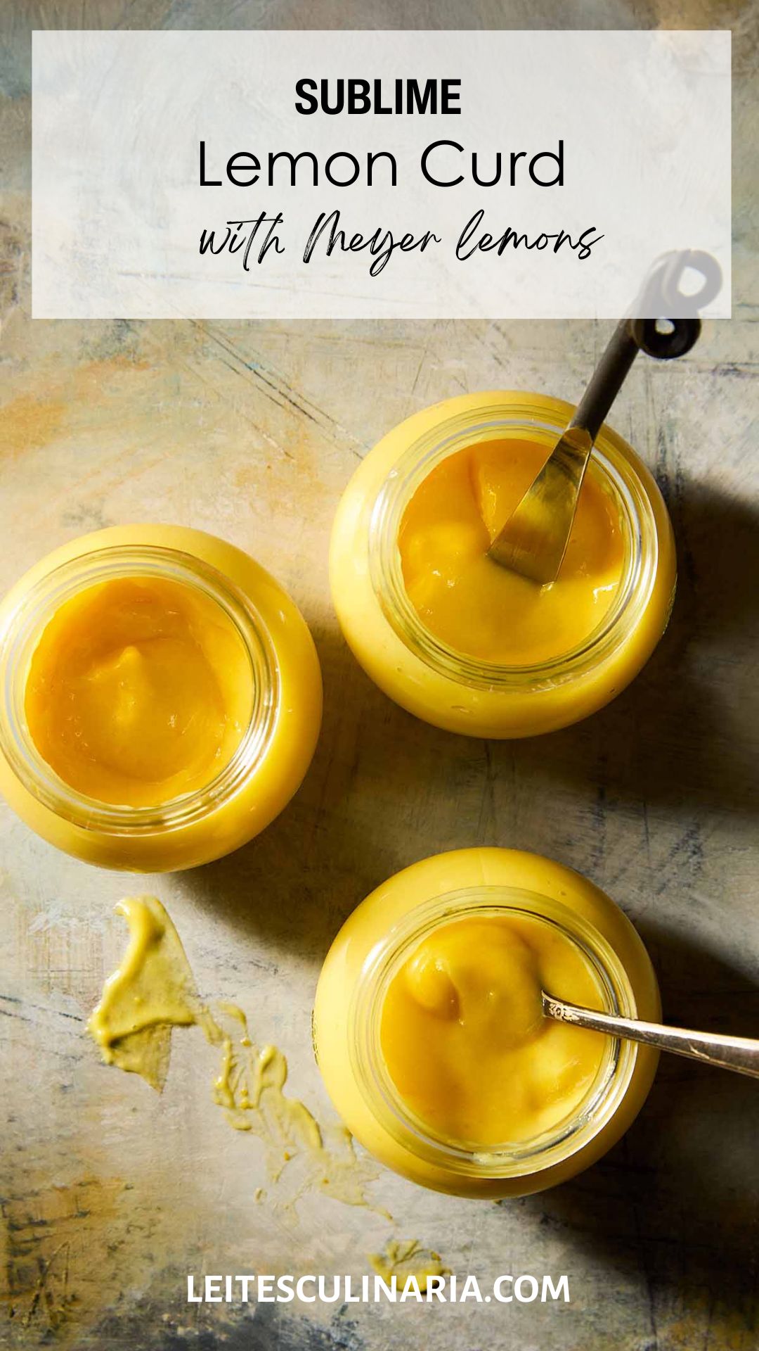 Three jars of homemade Meyer lemon curd, two with spoons in them.