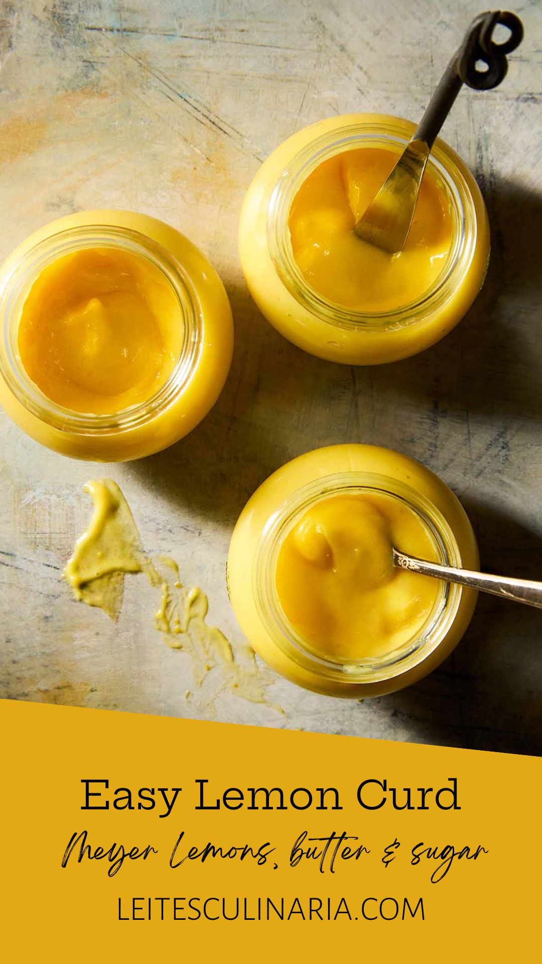 Three jars of homemade Meyer lemon curd, two with spoons in them.