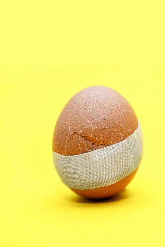 A cracked egg with a Bandaid on it.