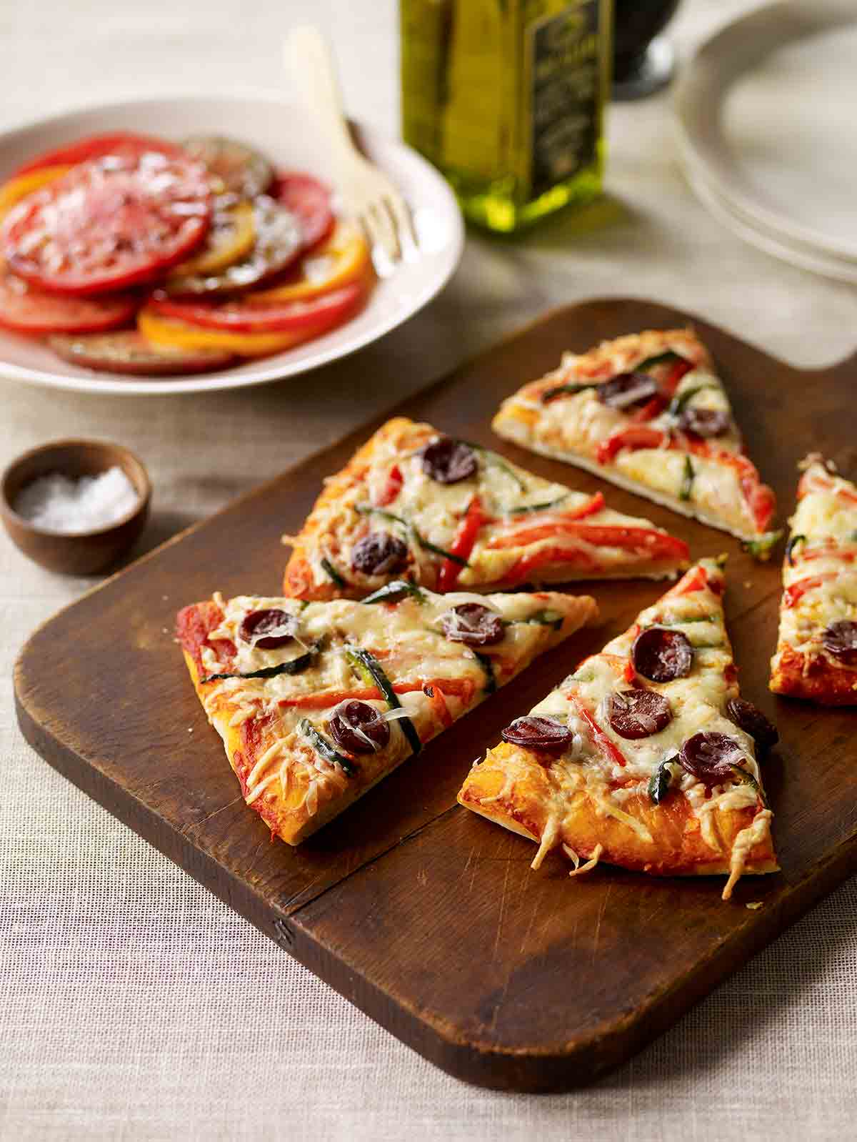 Five slices of Spanish pizza on a cutting board