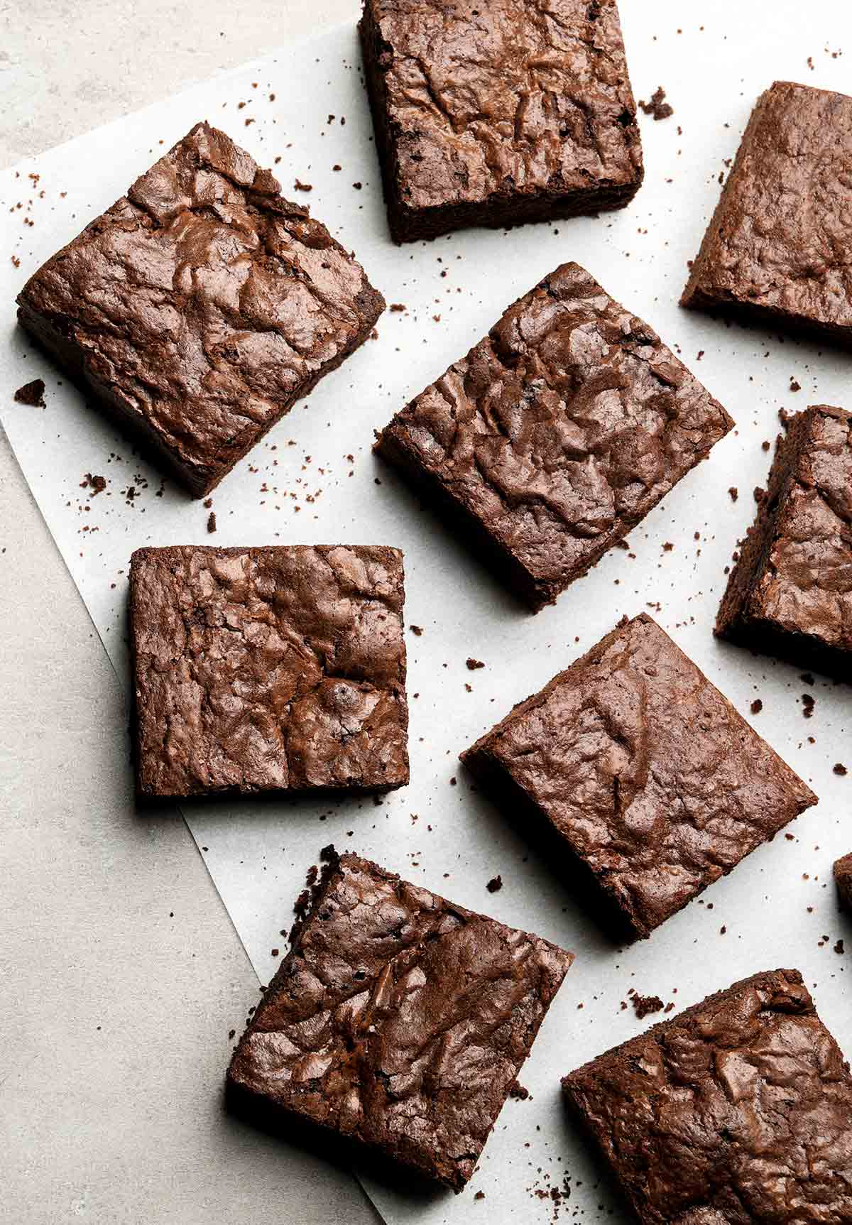 Squares of care-package brownies on parchment paper.