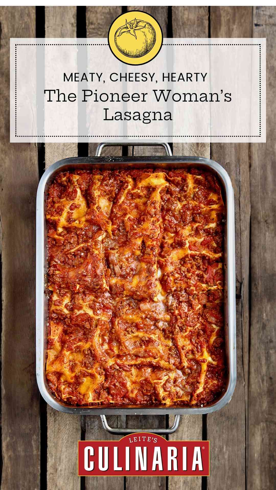 A metal baking dish filled with the Pioneer Woman's favorite lasagna on a wooden table.
