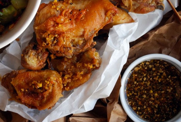 Octo vinaigrette in a white bowl next to a basket of fried chicken