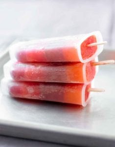 Three striped juice pops stacked on top of each other.