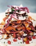 A pile of autumn coleslaw with apples, hazelnuts, red cabbage, beets, and pomegranate seeds
