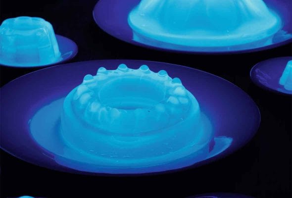 Several plates with fluorescent glowing Jello molds