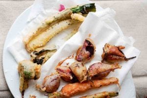 Vegetable tempura of zucchini, beets, carrots, squash on a paper towel on a plate