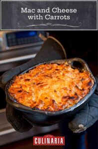A casserole dish of baked mac and cheese with carrots.