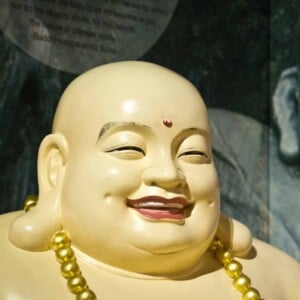 A statue of a fat smiling Buddha