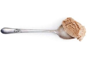 A scoop of black coffee ice cream on a silver spoon.