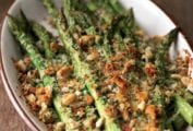 Oval casserole dish with spring asparagus and Asiago gratin, topped with coarse bread crumbs