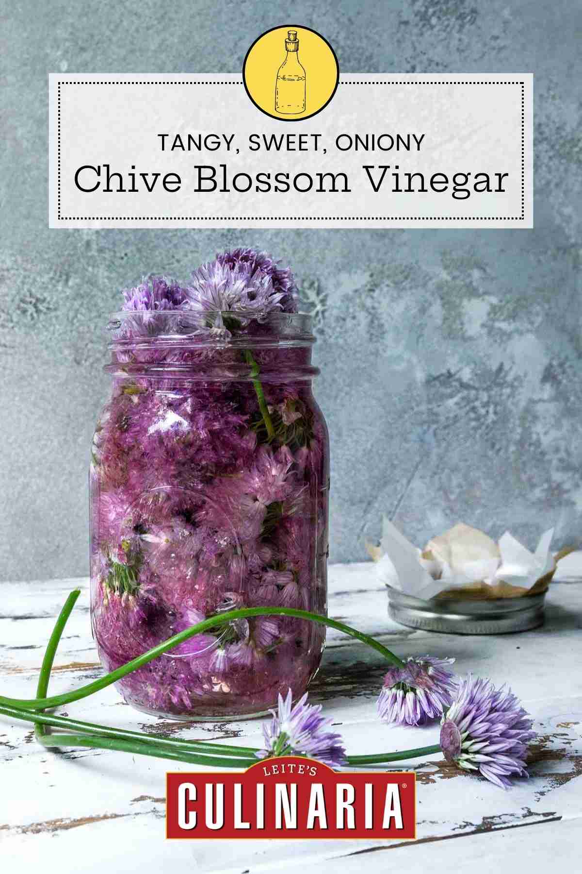 A Ball jar filled with chive blossom vinegar and the blossoms.