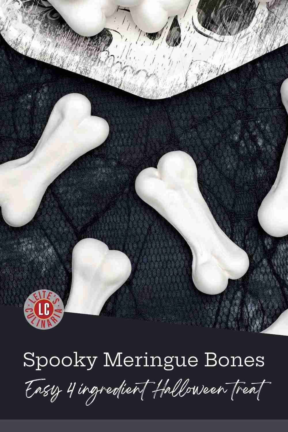 Crisp, white meringue skeleton bones piled on a paper plate against a black cobweb tablecloth.