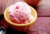 A yellow bowl filled with strawberry ice cream.
