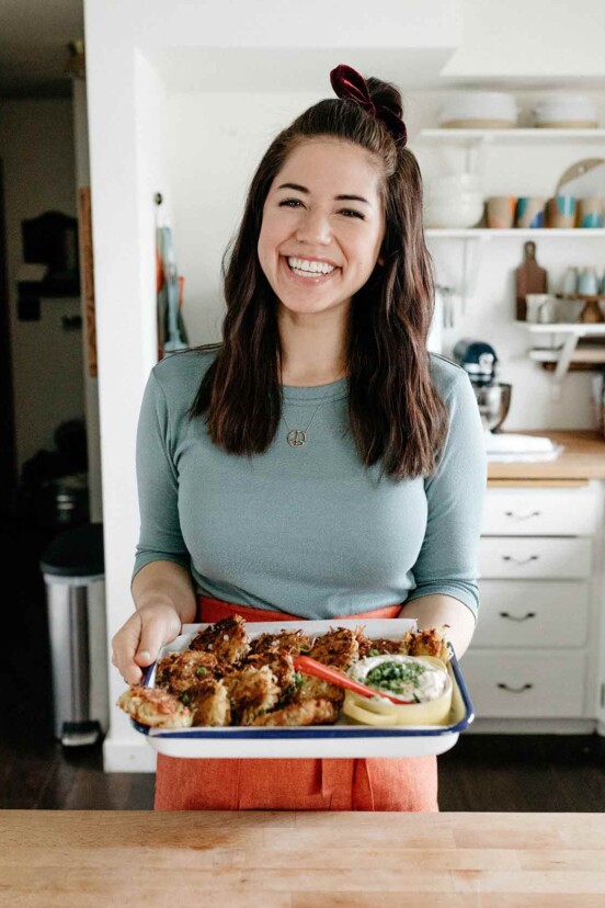 Molly Yeh in kitchen holding a platter.