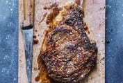 Cutting board and knife with a salt and pepper rib eye steak