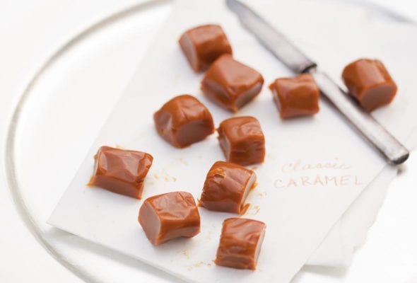 Pieces of classic caramels on a sheet of parchment.